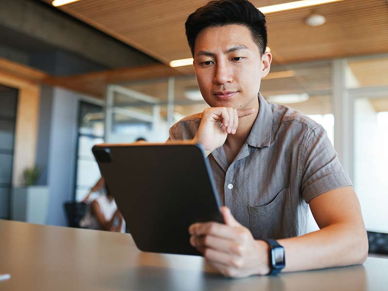 Family medicine resident studying with an ABFM-style question bank on a laptop, reviewing clinical vignettes and exam-style explanations.